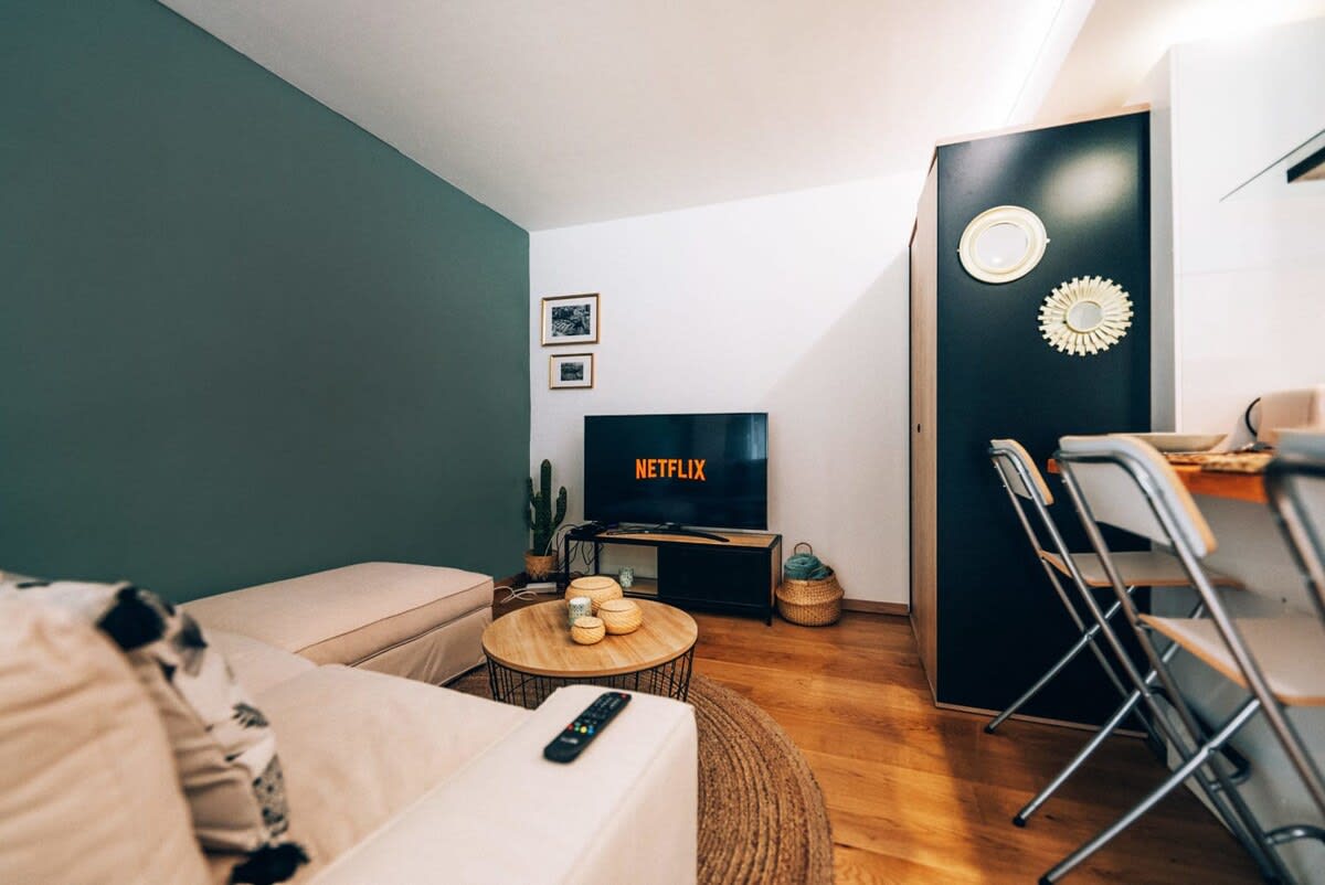 Cozy living area with a stylish sofa and flat-screen TV, providing a great spot to unwind and enjoy your favorite shows.