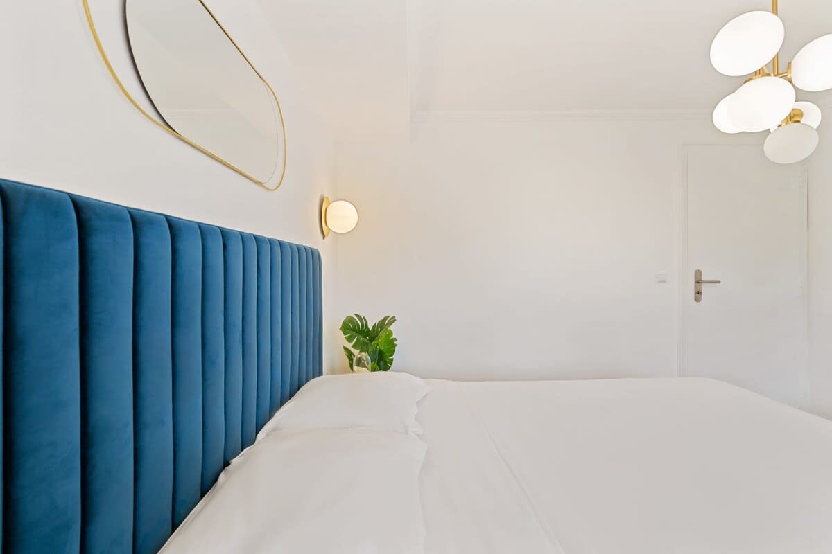 Modern bedroom featuring plush bedding and a serene atmosphere.