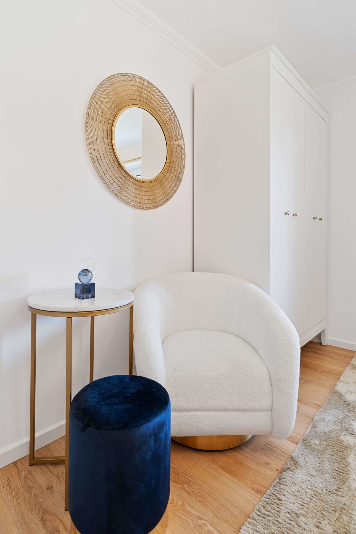 Cozy corner with a plush chair and elegant decor, perfect for relaxing.