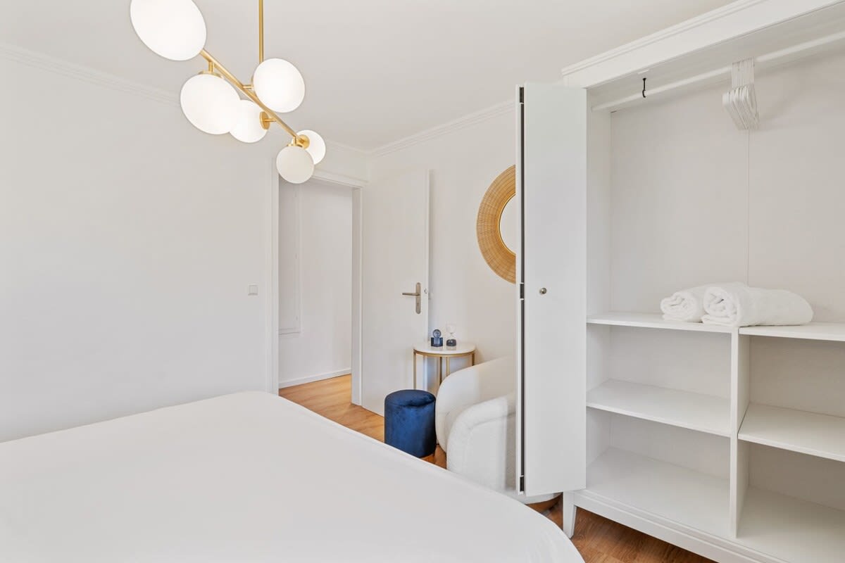 Spacious wardrobe and cozy chair, offering plenty of storage and a spot to unwind.