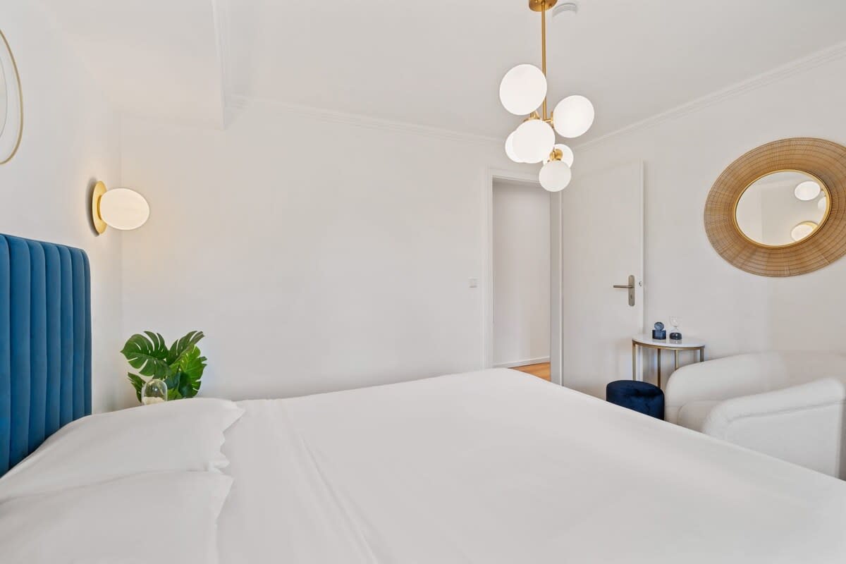Bright and modern bedroom with stylish lighting and comfortable seating.