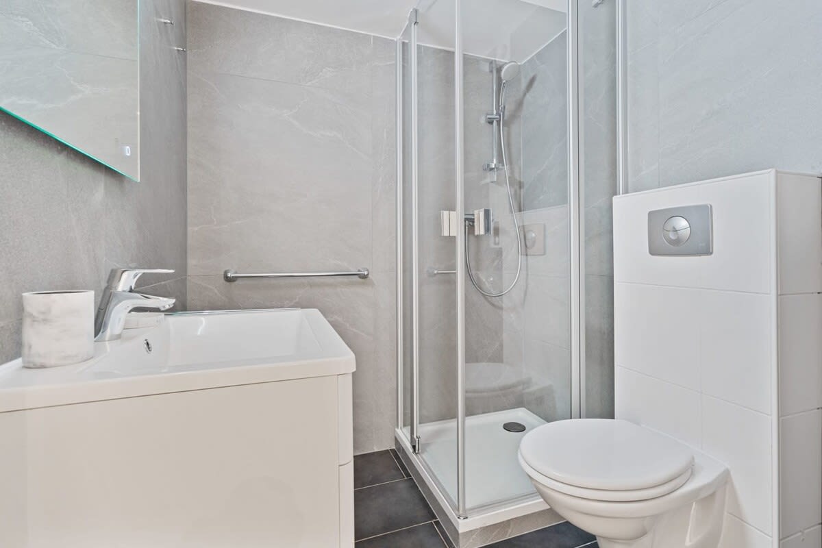Elegant bathroom featuring modern amenities and a spacious shower.