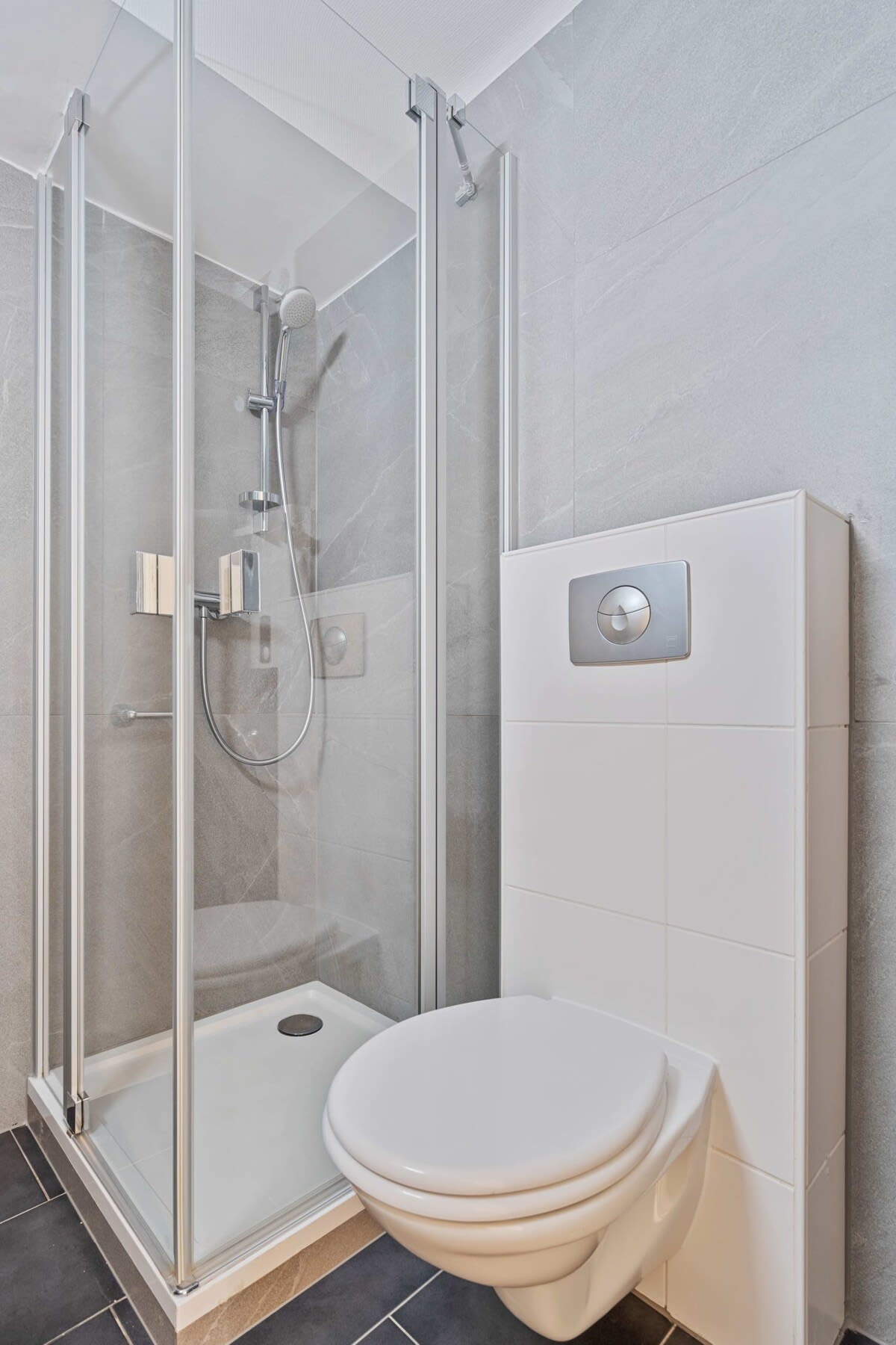 Compact and stylish bathroom with a sleek shower and contemporary fixtures.