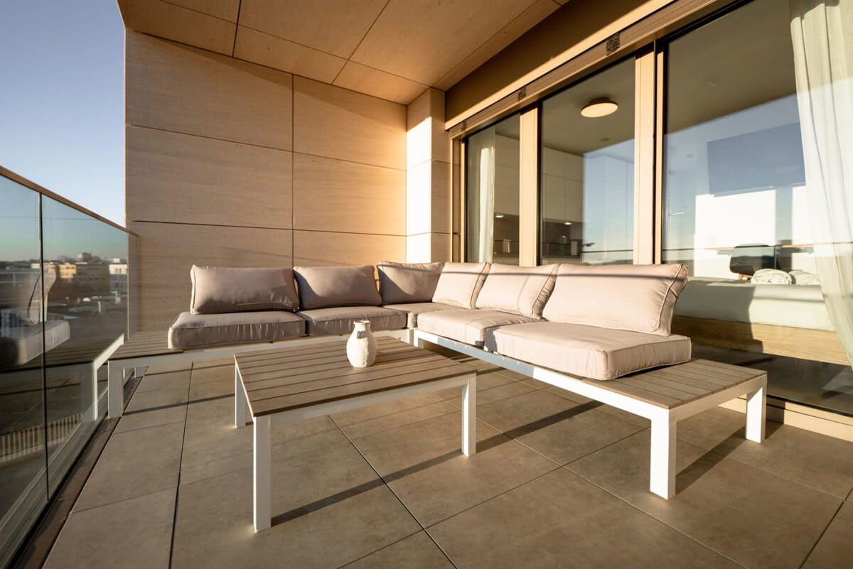 Spacious outdoor lounge with plush seating, perfect for enjoying sunsets and city views.