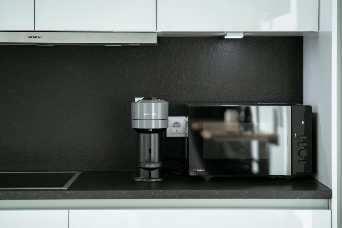 Compact and modern kitchen amenities provide all you need for a hassle-free stay.