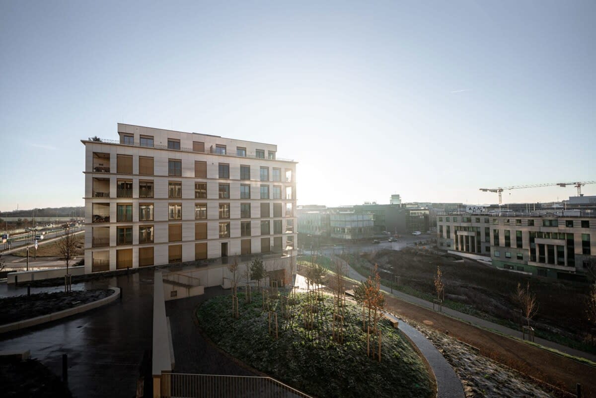 Stunning view of the surrounding area from the apartment, showcasing modern architecture and serene green spaces.