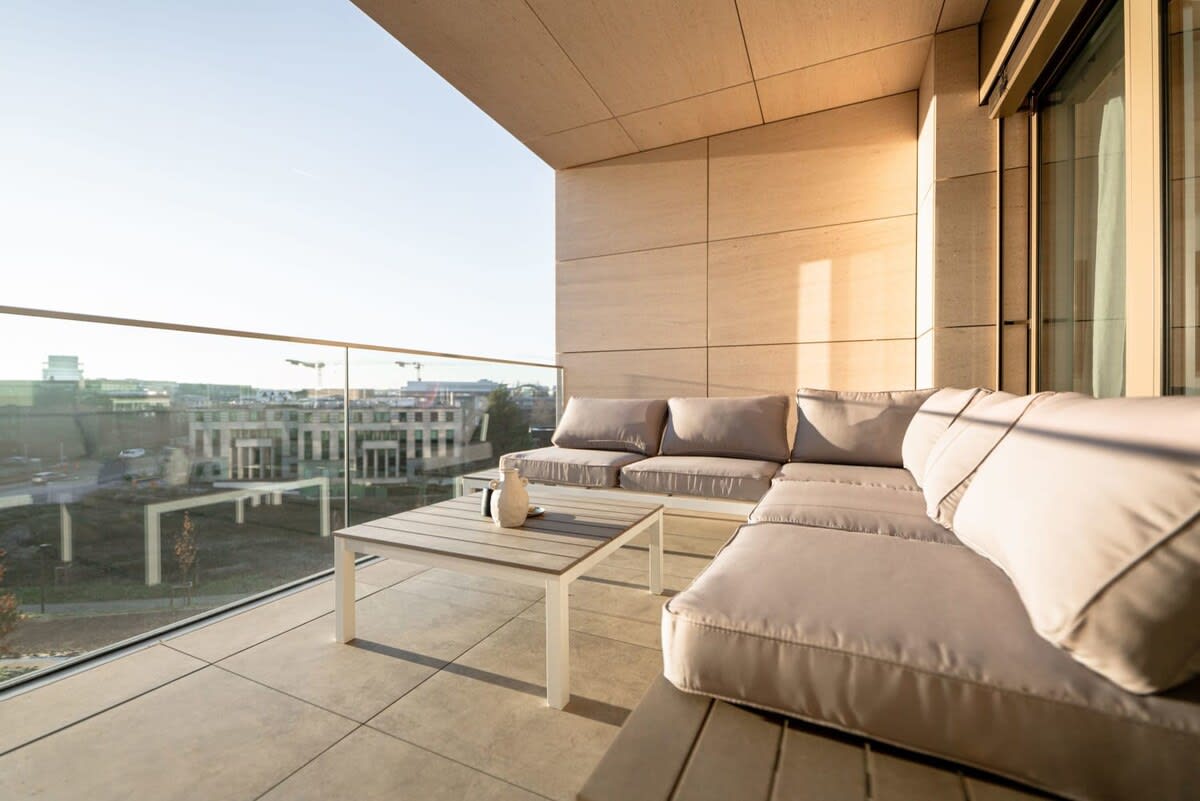 Spacious outdoor lounge with plush seating, perfect for enjoying sunsets and city views.