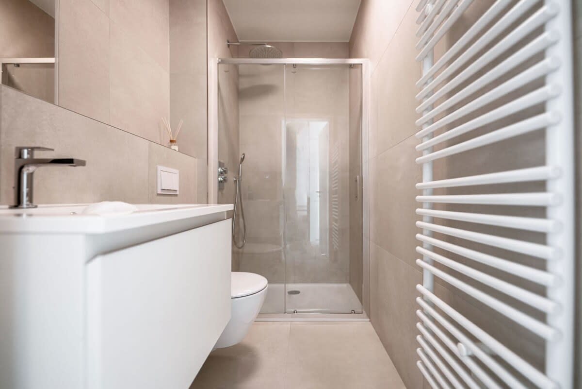 Elegant and modern bathroom with a spacious walk-in shower and sleek fixtures, offering a spa-like experience.