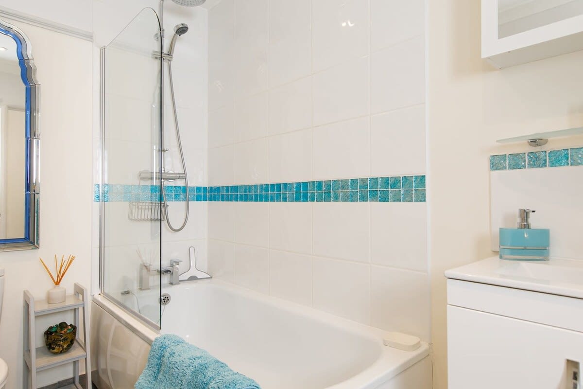 The family bathroom has essential toiletries such as hand soap and body wash.