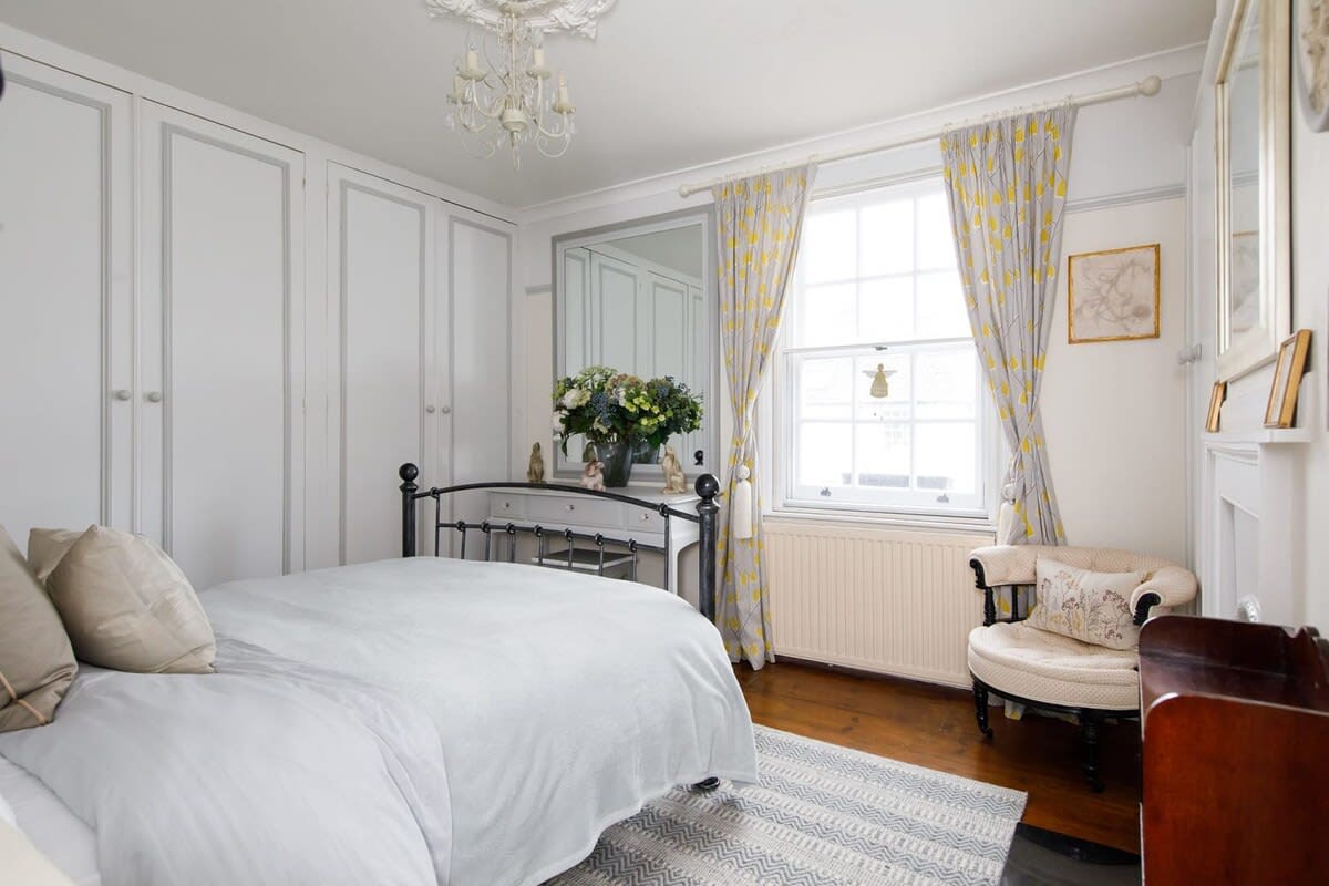 The main double room has a cottage feel, with feature fireplace, floorboards and homely touches.