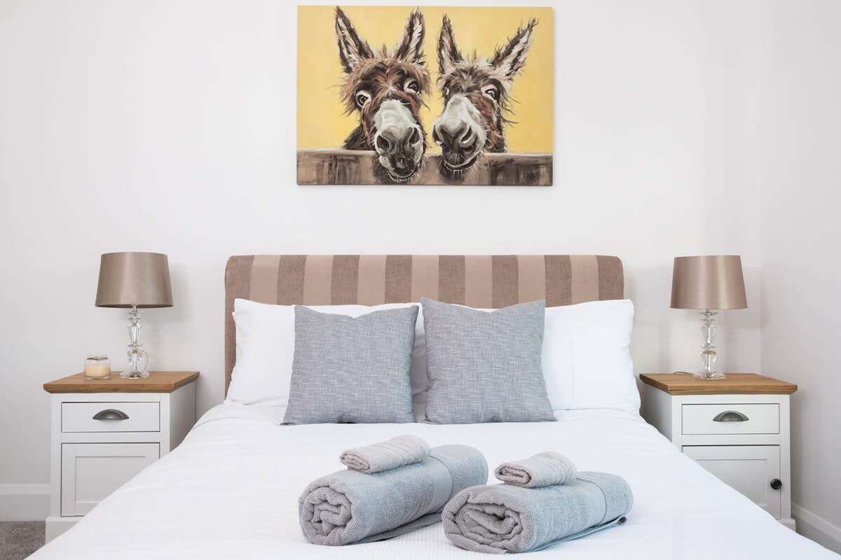 A couple of friendly faces watch over one of the double beds.