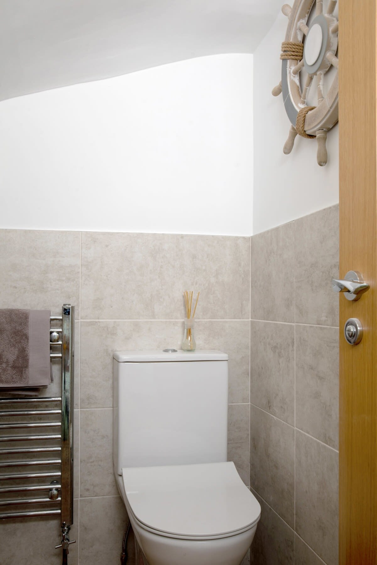 The ship's wheel leaves you in no doubt that this house is by the sea