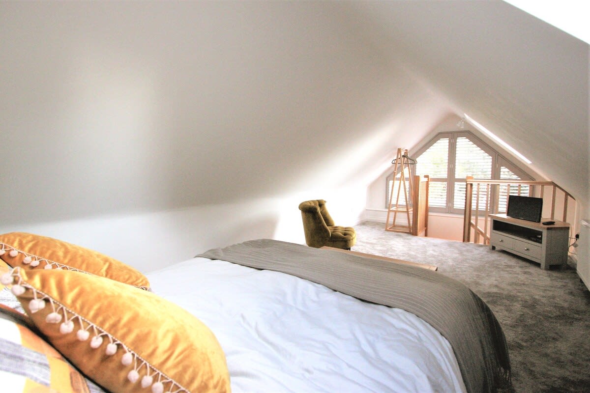 Beautiful Bedroom with large Window that lets the light flood in and LCD TV