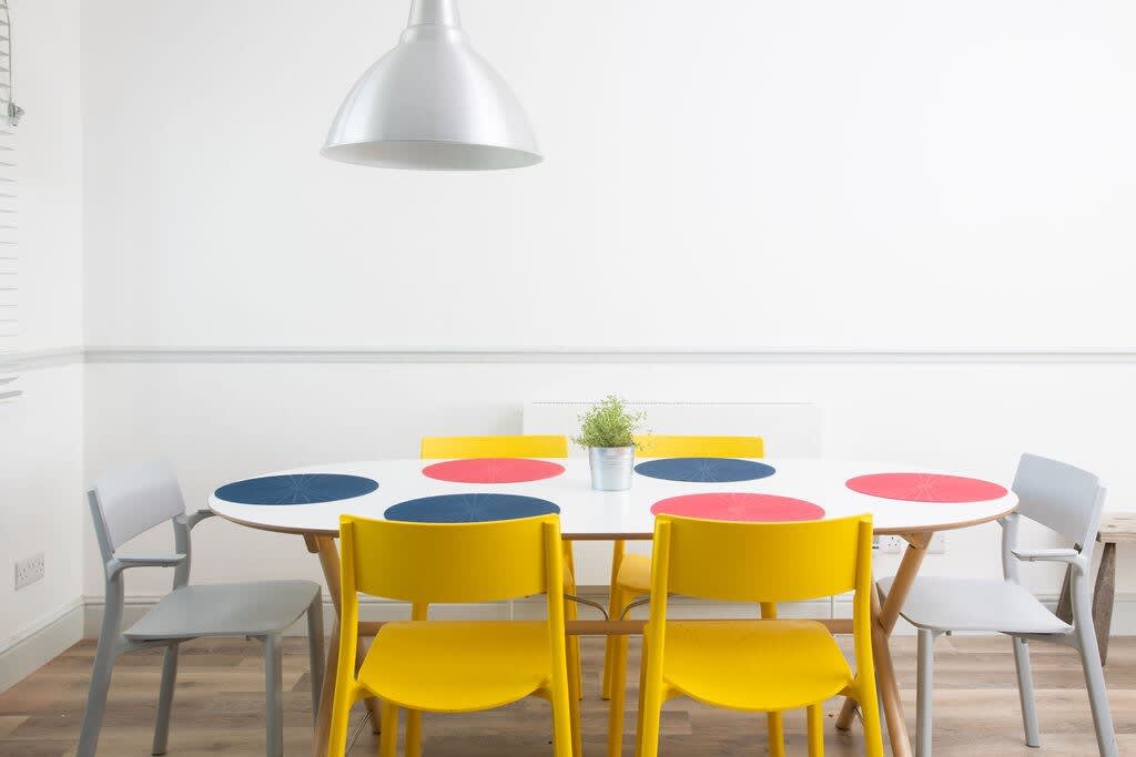 The spacious dining table comfortably seats 6 people.