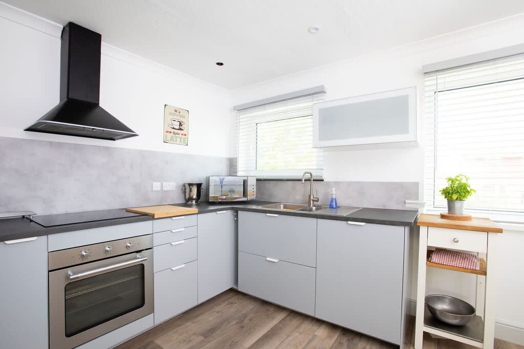 The kitchen is fully equipped and has two windows to let the light flood in.