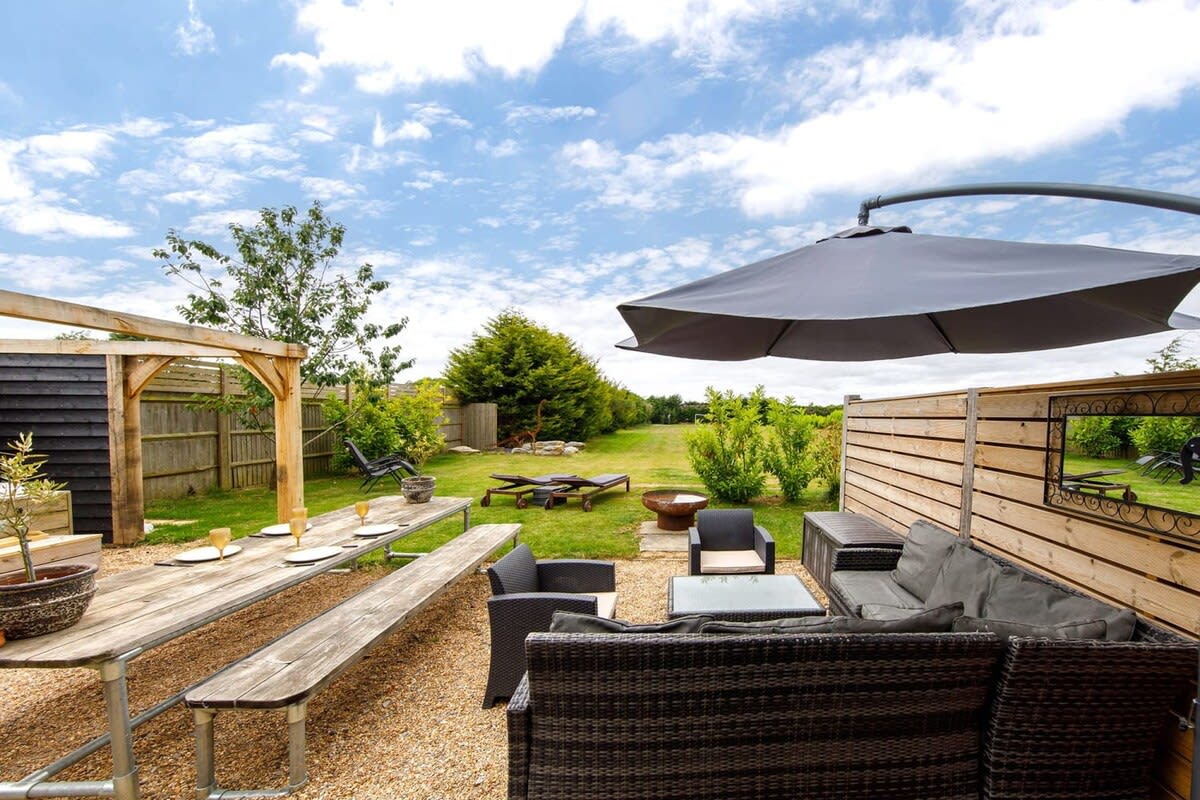 The superb outdoor space has plenty of places to sit, drink and dine. Not to mention the hot tub!
