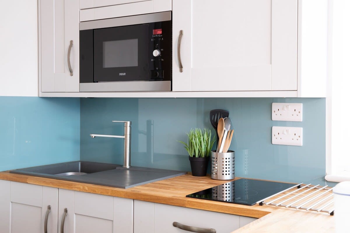 The compact but functional kitchenette has a stove, microwave, kettle and toaster.