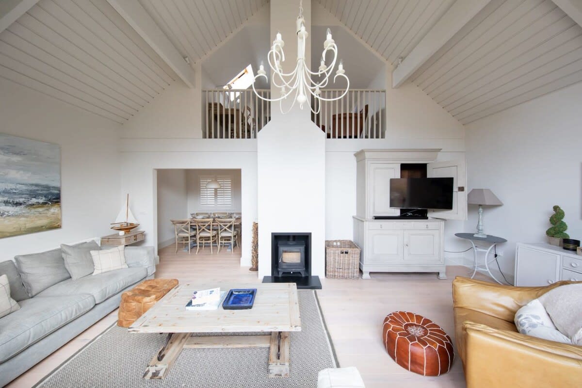 This home has a spacious lounge with comfy sofas, armchairs and log fire.