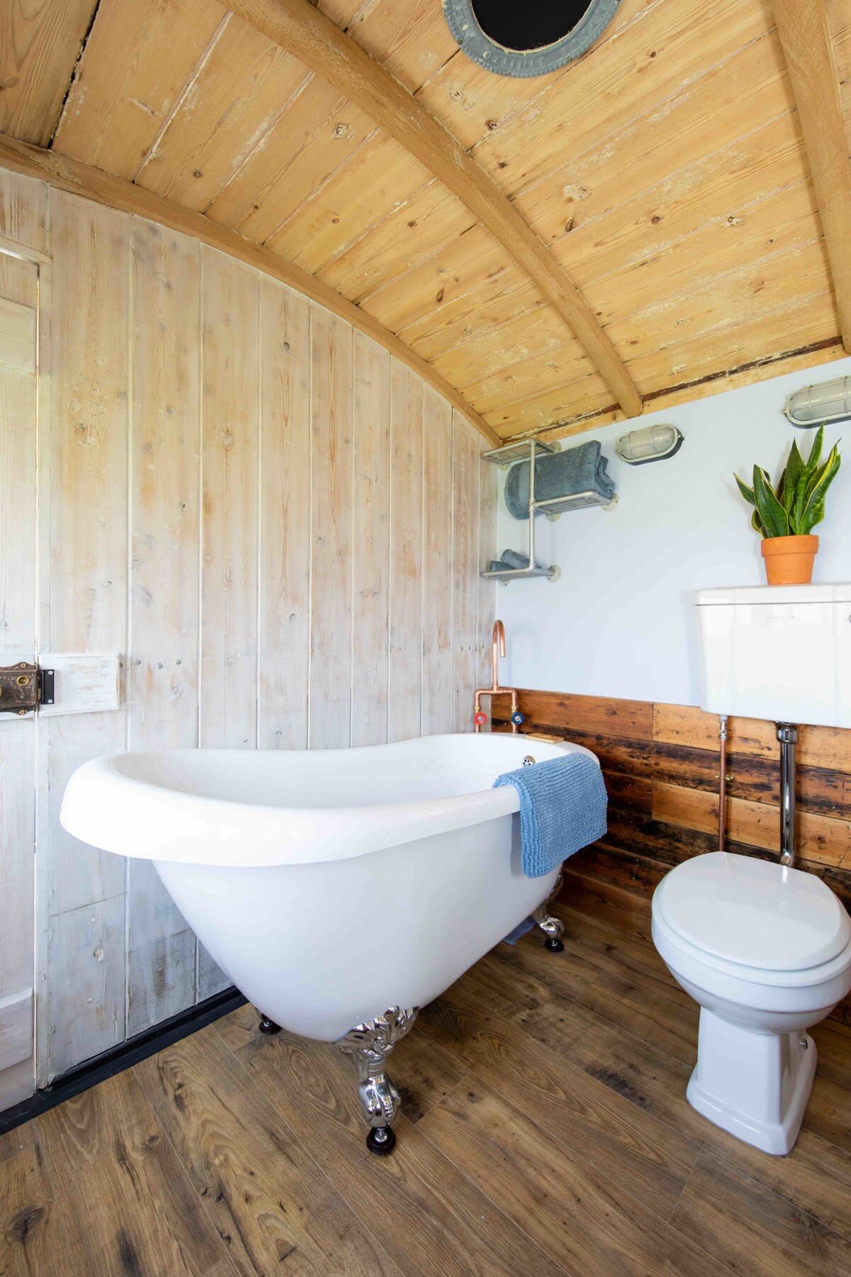 The spacious, cladded bathroom with free standing bath.