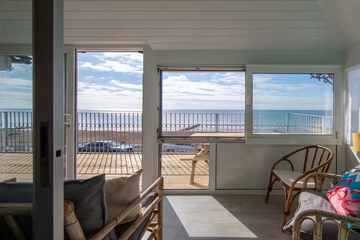 Relax in the warm sunroom with stunning beachfront views