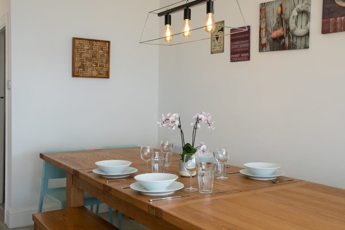 Eat together at the dining table with chic bench seating and space for everyone to come together