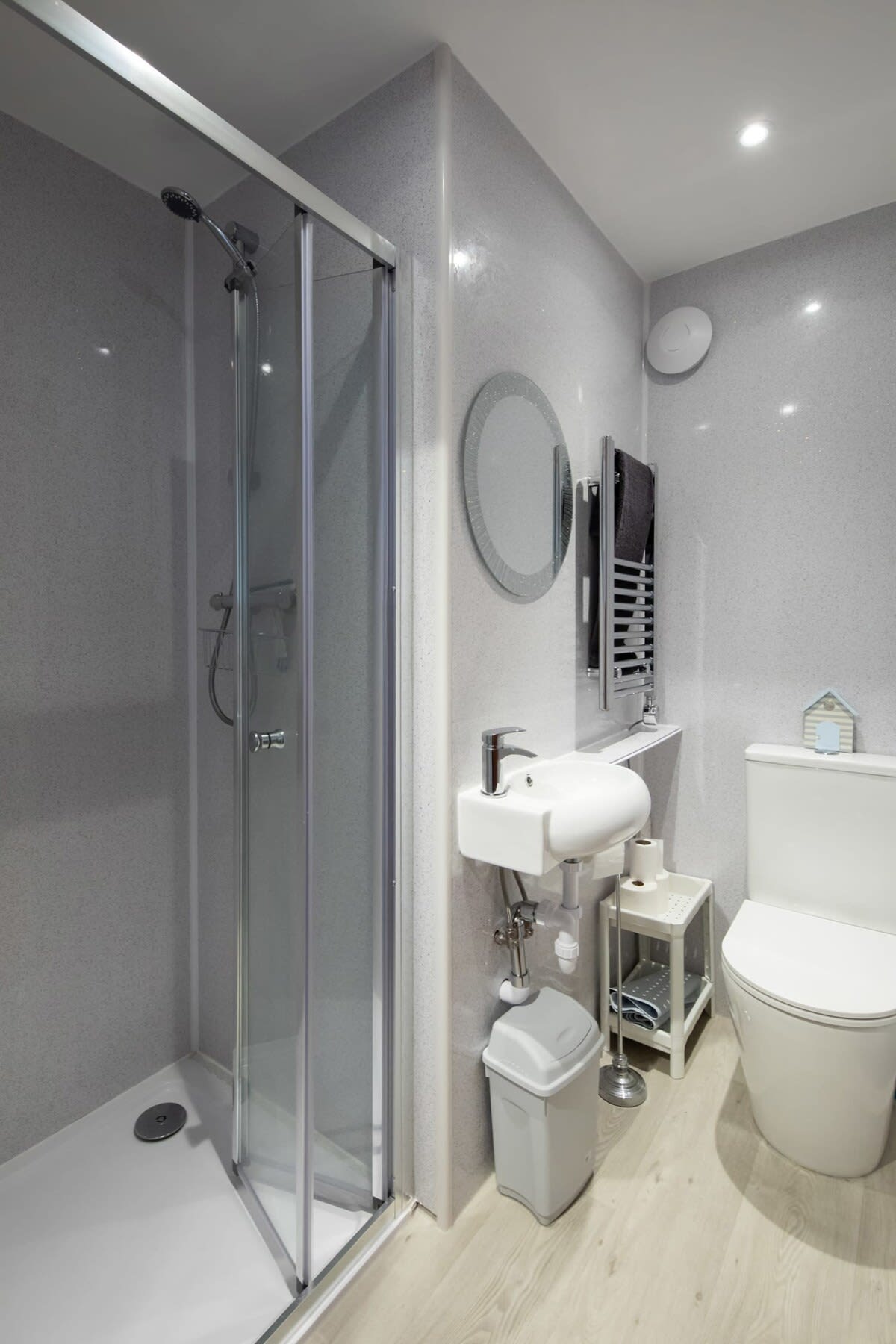 The modern upstairs bathroom with a walk in shower and a heated towel rail