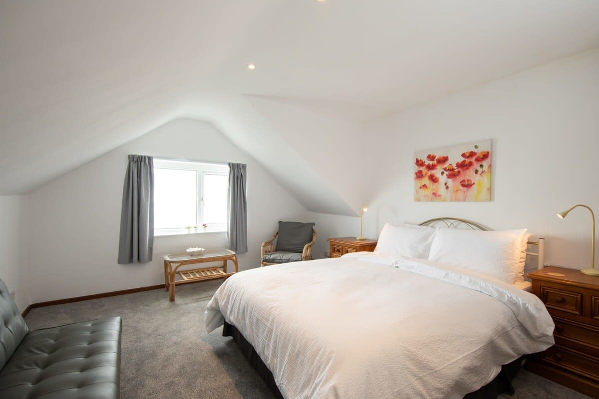 The gorgeous loft style master bedroom with a luxuriously large king bed