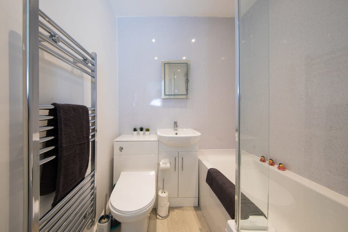 The central family bathroom with a full size bath and overhead shower