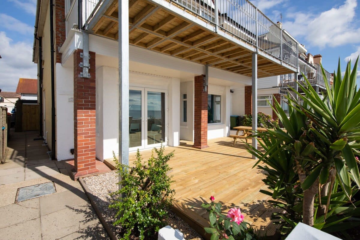 Surrounded by lush gardens, the front deck is perfect for entertaining