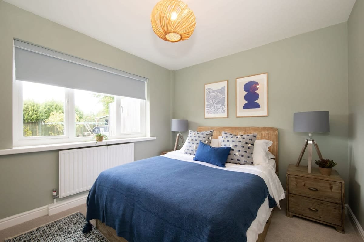 The spacious and bright king-size bedroom with soft furnishings