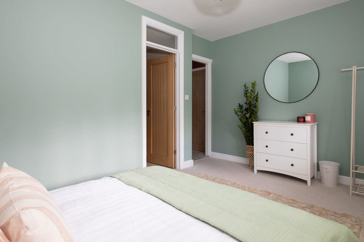 The room includes a mirror and storage space