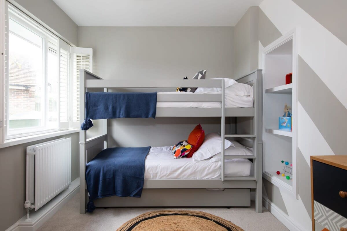 The children’s room includes a bunk bed and trundle