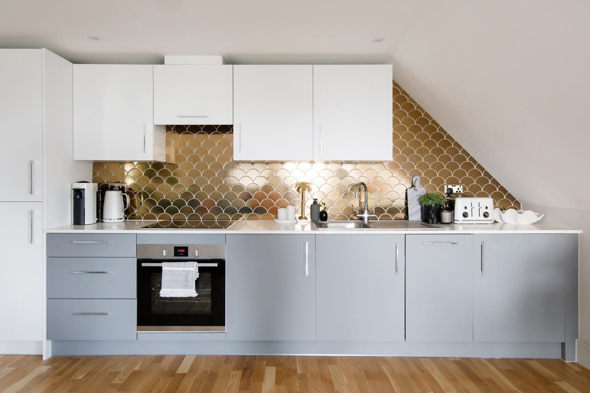 The north wall of the penthouse is covered with a contemporary, fully equipped kitchen.