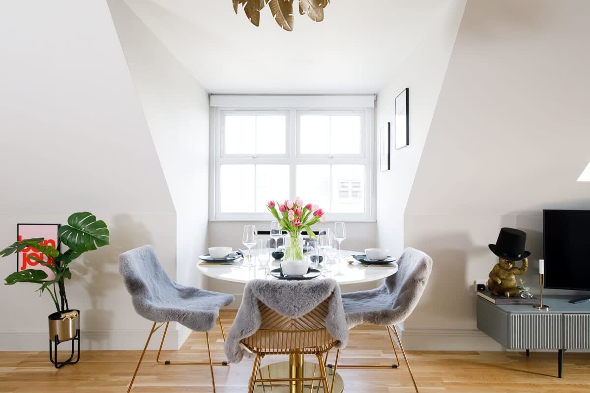 Enjoy breakfast or an evening meal in the relaxed, bright dining space by the large window.