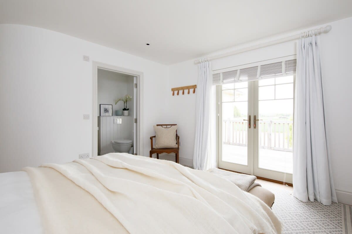 This bedroom has direct access to the upper floor balcony