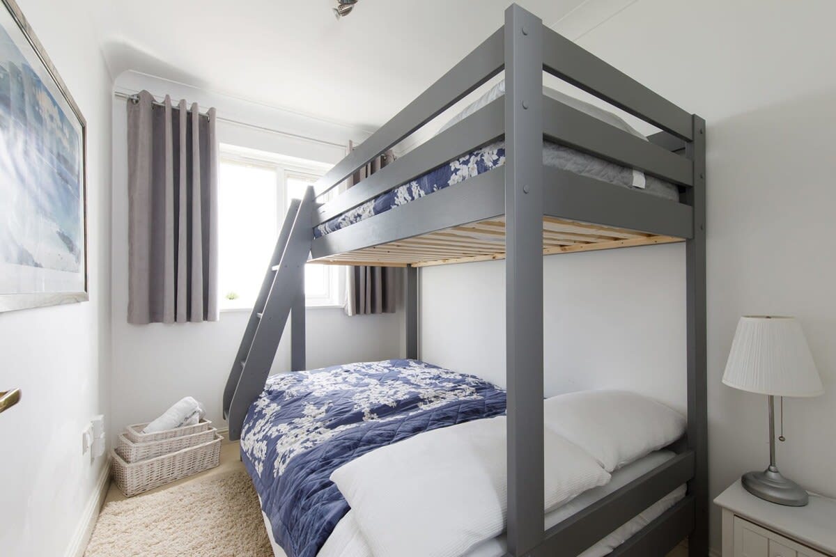 The third room has bunk beds, with a single at the top and small double at the bottom.