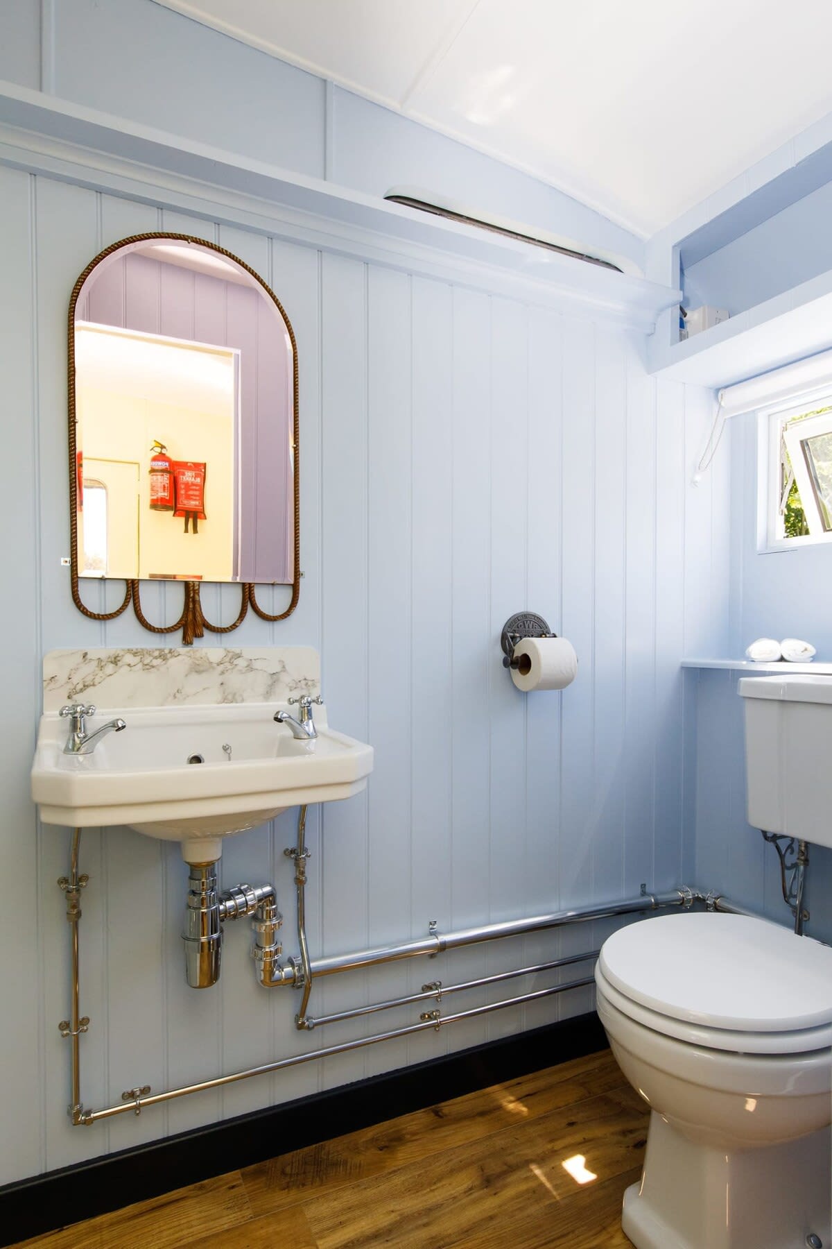 The powder blue shower room has vintage fixtures and fitting to continue the theme.