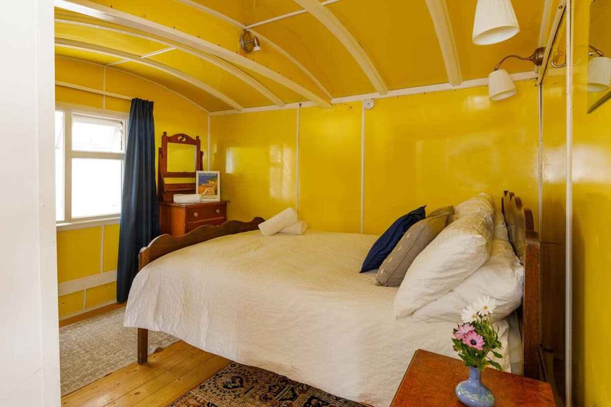 The second double room is unique and vibrant with the original train carriage exposed.