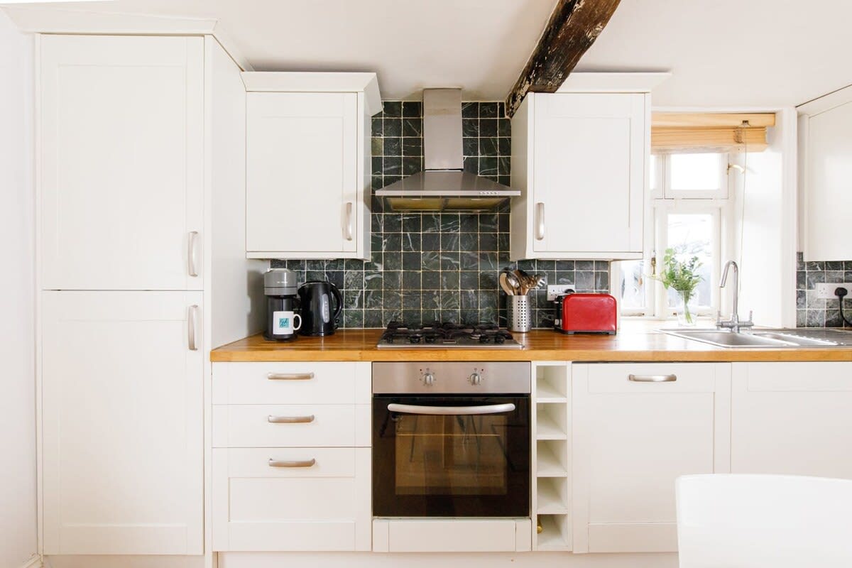 Spacious and bright, the kitchen has plenty of countertop space for cooking.