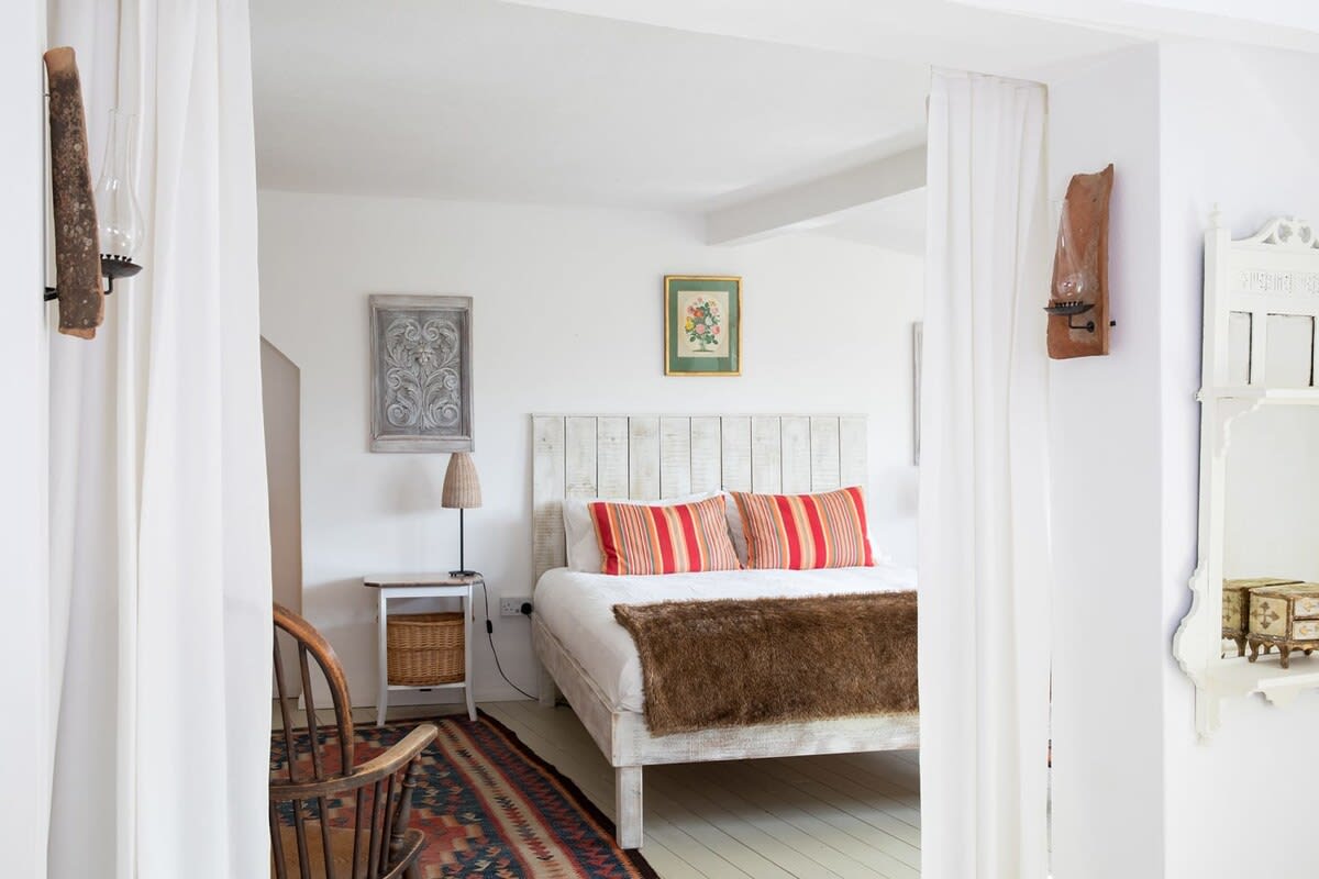 The master bedroom has a luxury king bed with pillows, cushions and throws for a dreamy night’s sleep.