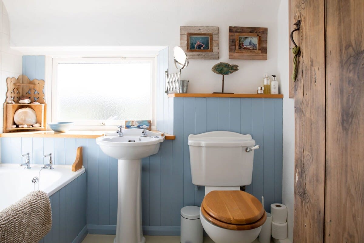 The full family bathroom has a bath, overhead shower, sink and WC.