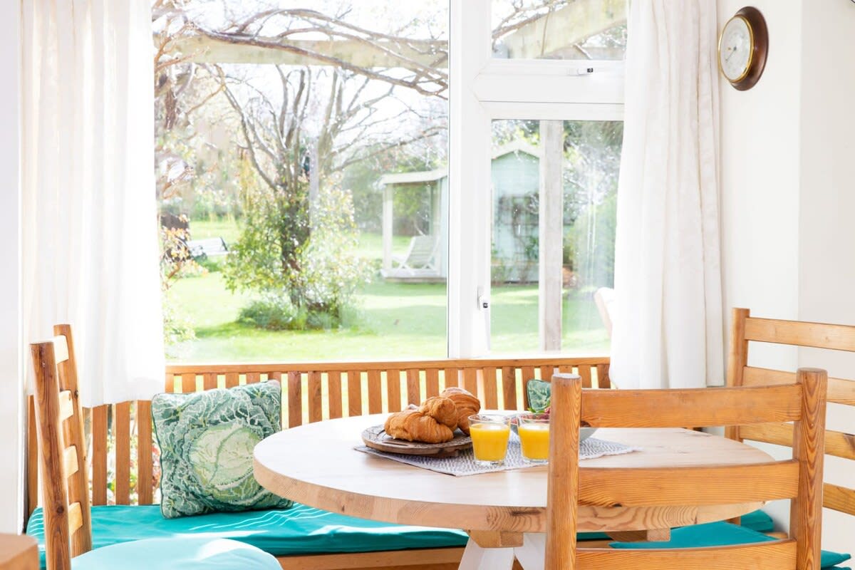 The breakfast table off from the kitchen looks out to the garden.