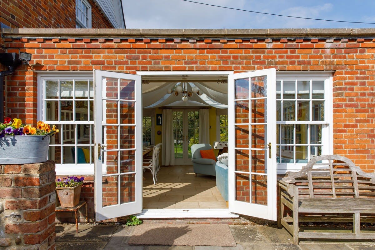 The orangery opens up to a sunny patio. Sit in the sun with your morning tea.