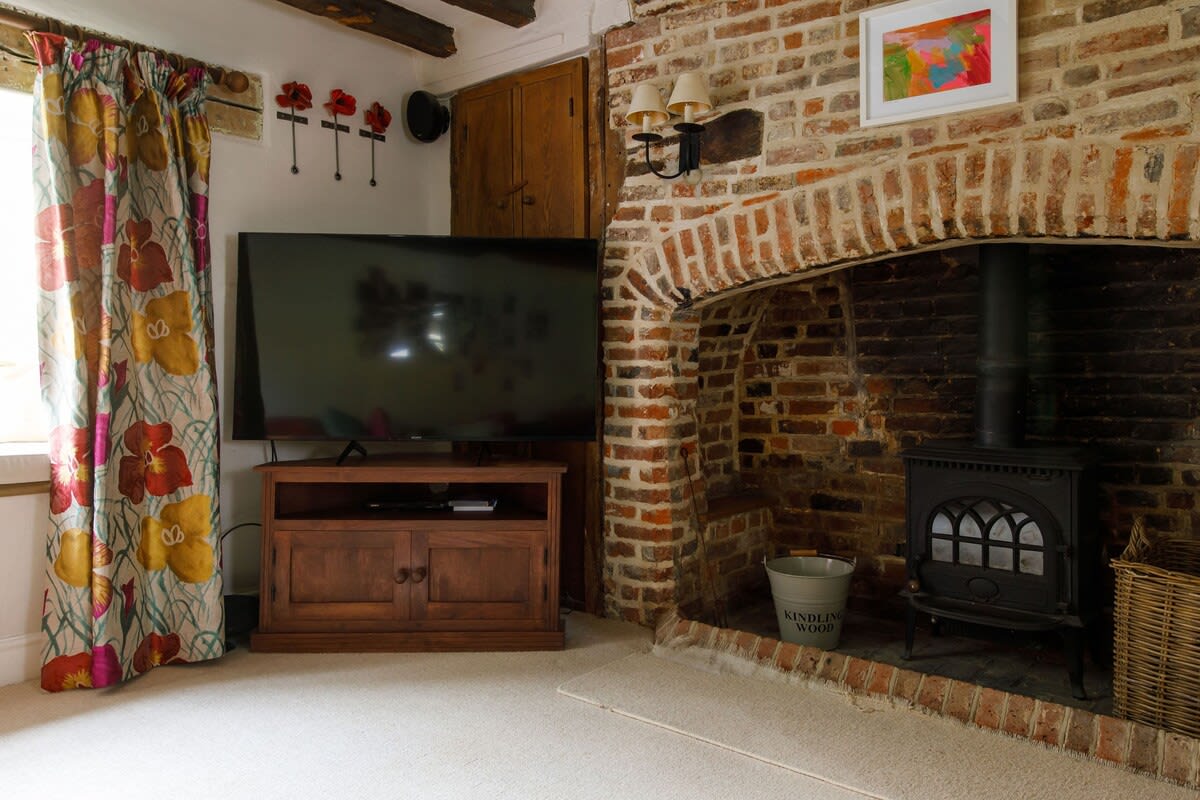 This lounge has a Smart TV and log burner for cosy evenings when the weather is cooler.