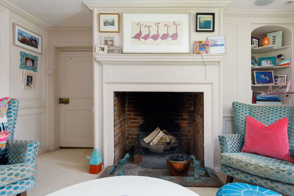 The home has original features throughout, such as fireplaces, wooden beams and exposed brick.