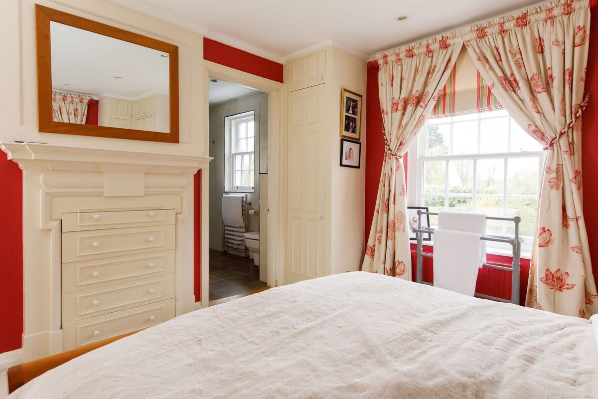 The king bedroom is decorated in creams and reds, and has plenty of storage space for your belongings.