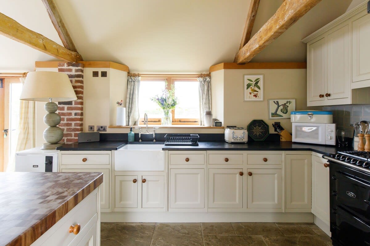 The kitchen has spacious worktops for cooking.