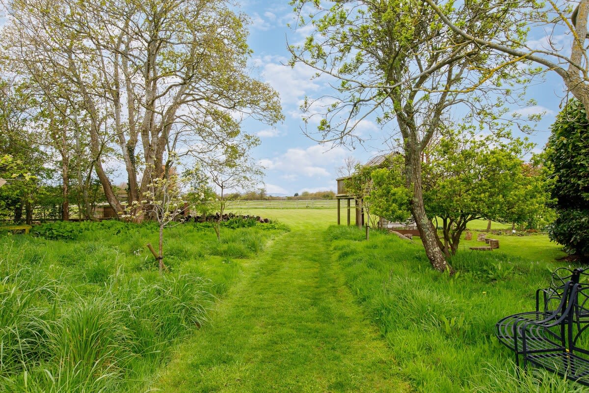 The home has extensive grounds, surrounded by lush countryside.