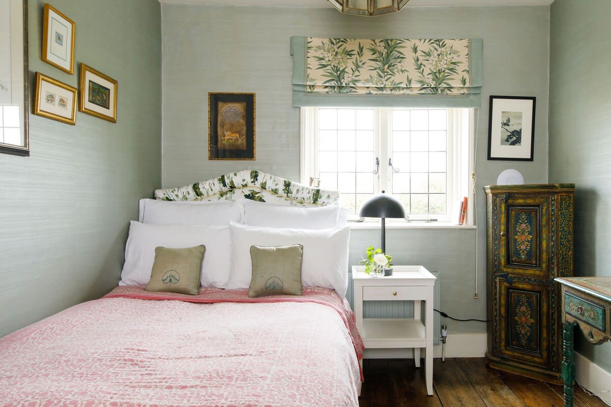 The second bedroom is a beautiful king, with antique furniture, patterned textiles and luxury bedding.