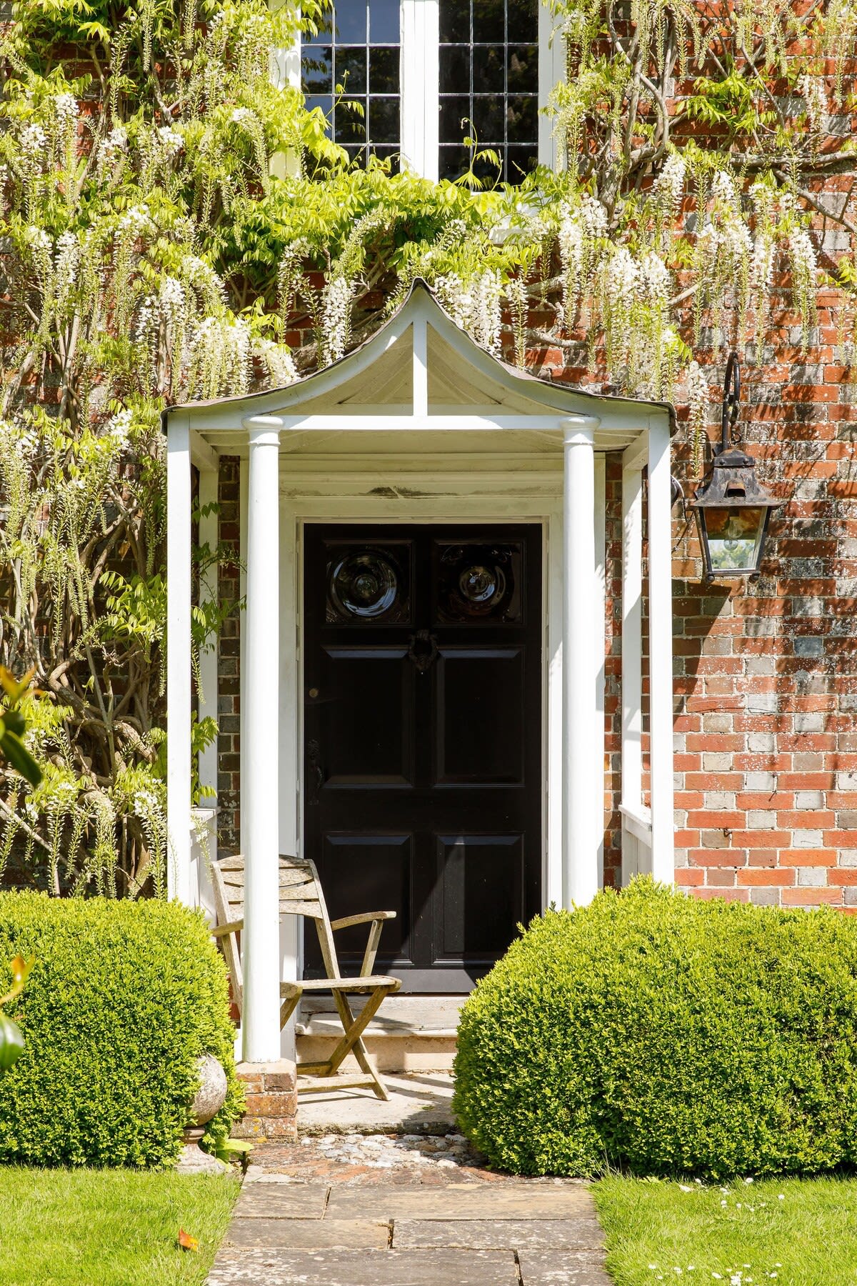Stunning Wisteria covers the front of the main house.